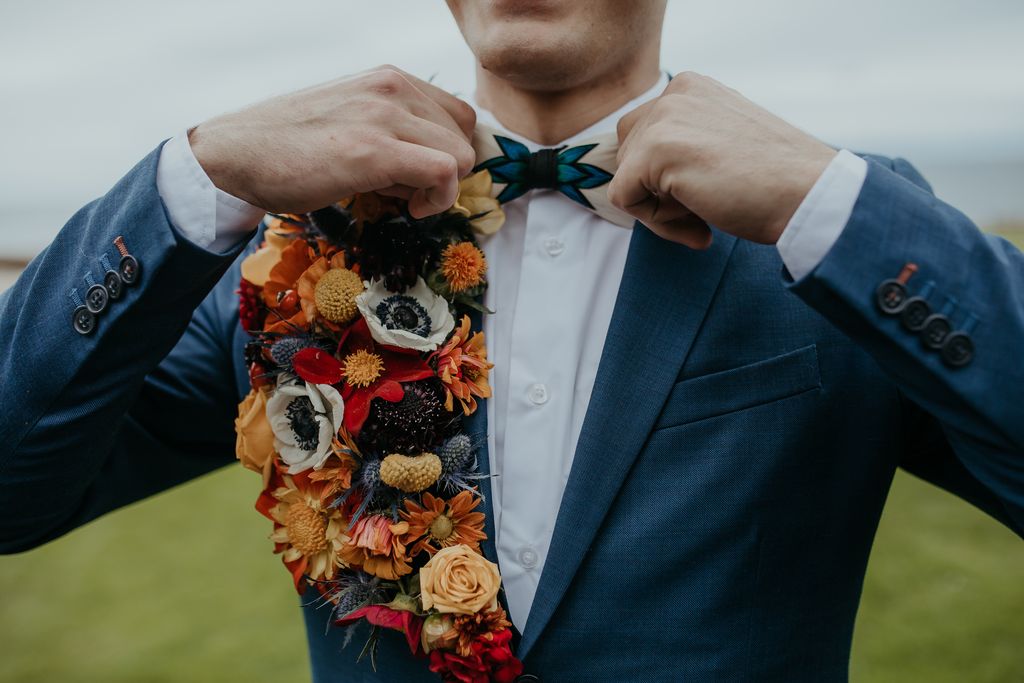 groom in blue suit with floral lapel by West Coast Floral Design
