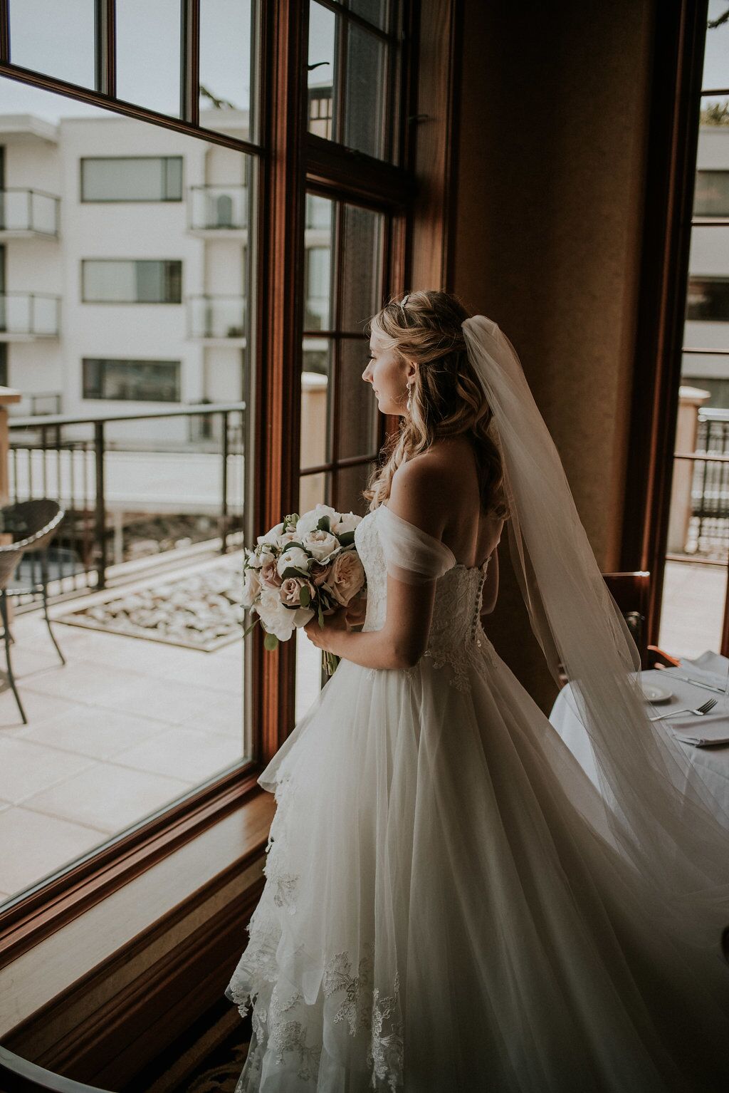 Romantic Bride at Oak Bay Beach Hotel looks out towards the ocean
