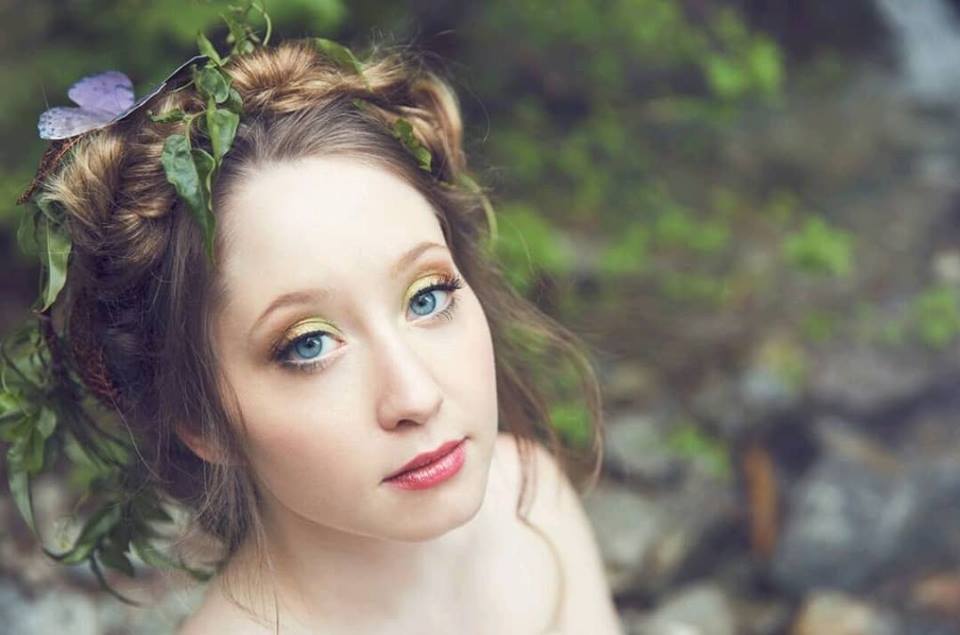 Whimsical Woodland Bride with ferns and butterfly in her braided hair