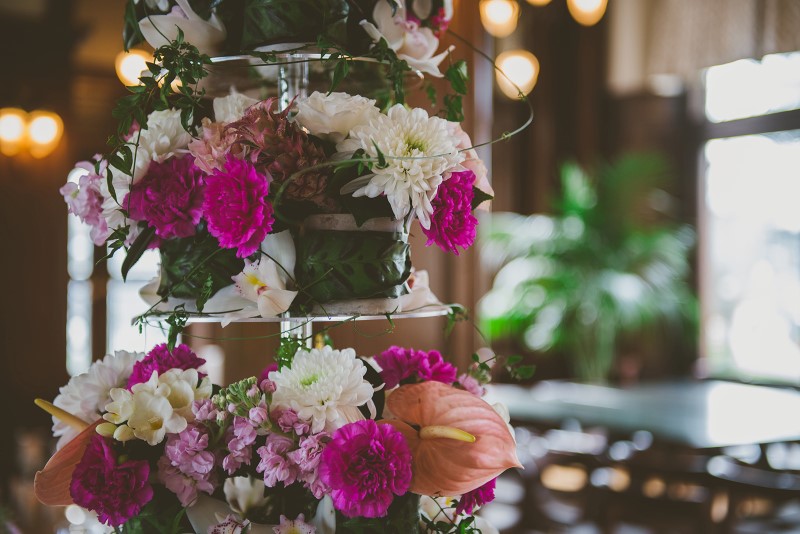 Tropical Empress Wedding Flowers featuring pink and white reception table by Brown's the Florist