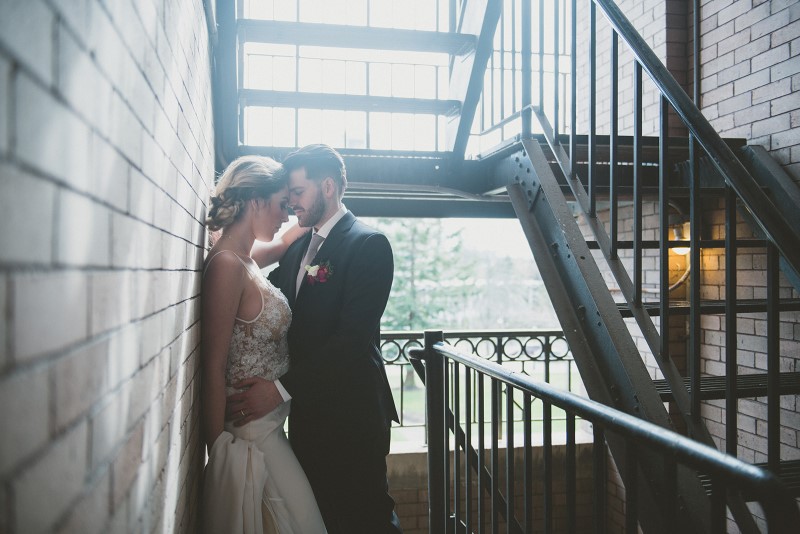 Couple in stairwell Shades of White Bridal on Vancouver Island