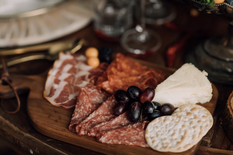 Culture Fusion charcuterie board with grapes, crackers, salami and prosciutto