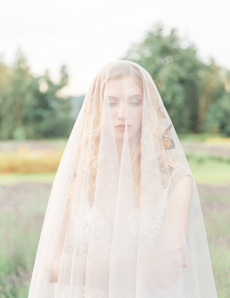 Bride with long veil over her by Luxx Nova Vancouver