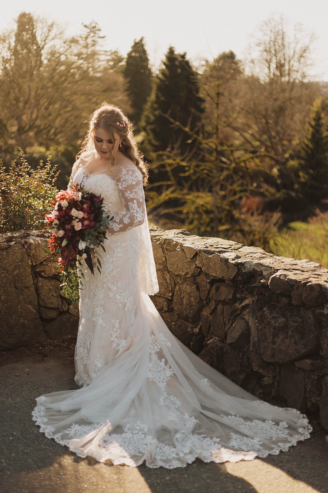 Bride with cascading bouquet and lace gown by Blush Victoria by Kacie McColm PHotography