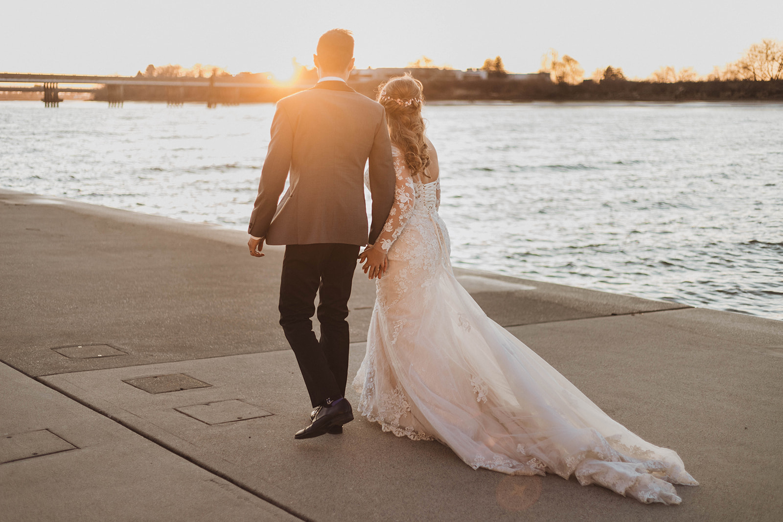 UBC Boathouse Wedding Couple Ruby and Roy walk along the Vancouver water edge