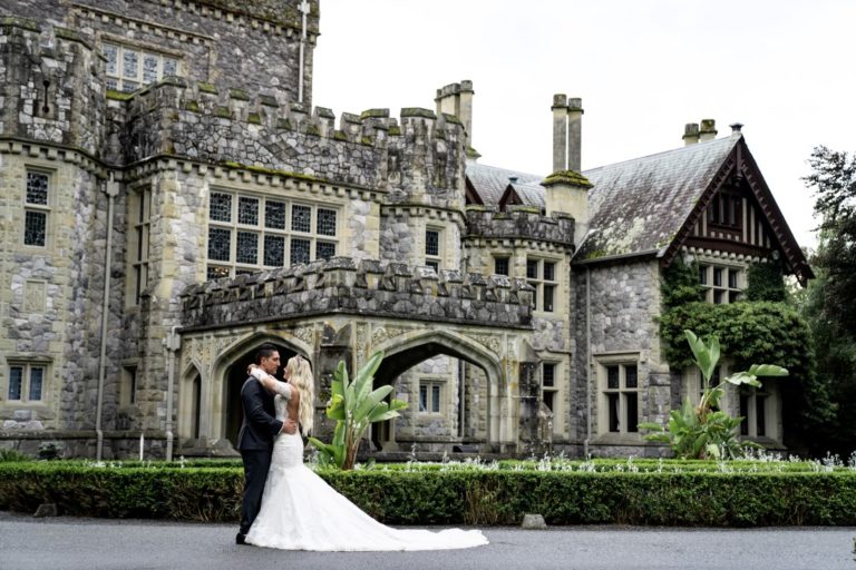 Hatley Castle newlyweds pose in front of ivy covered walls on Vancouver Island