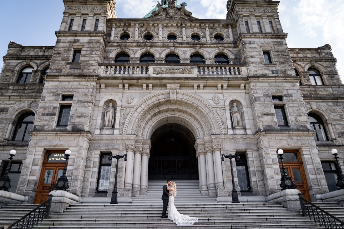 Newlyweds in front of BC Parliament by Ross Kyjer Photography
