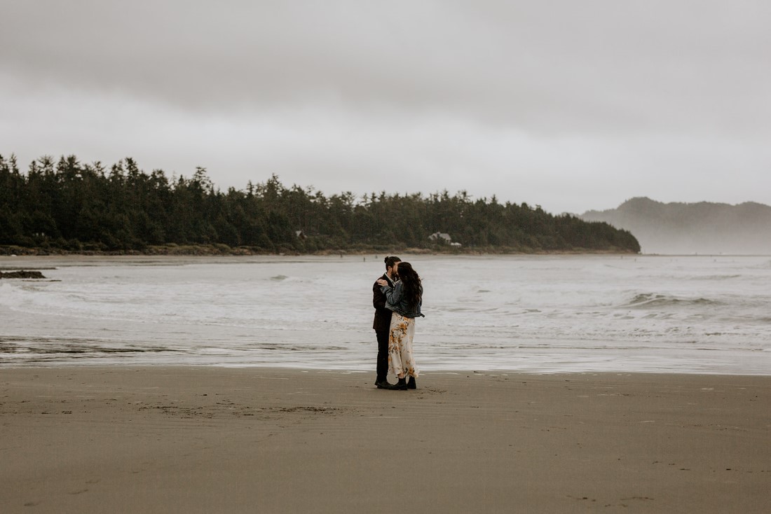 Wickaninnish Eloping couple along the waters edge of Chesterman Beach