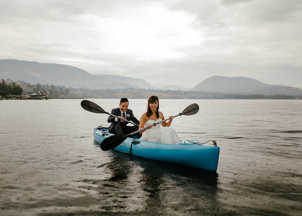 Newlyweds paddle canoe across lake in Okanagan
