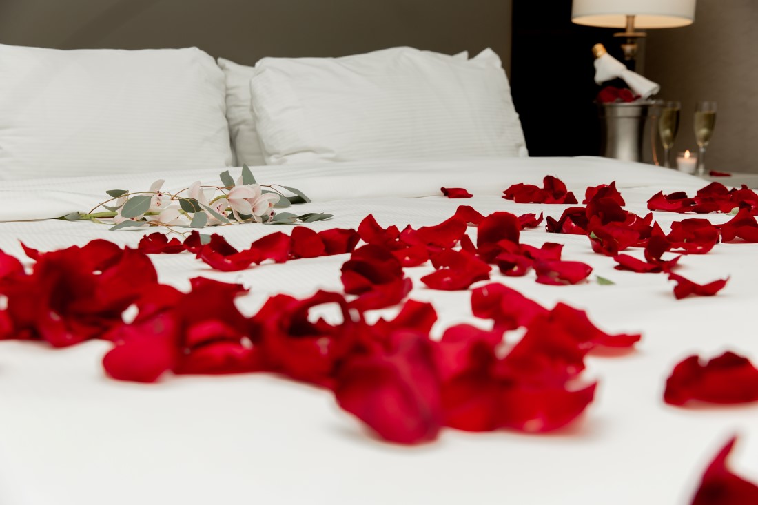 Rose petals on white bed at Vancouver Hilton