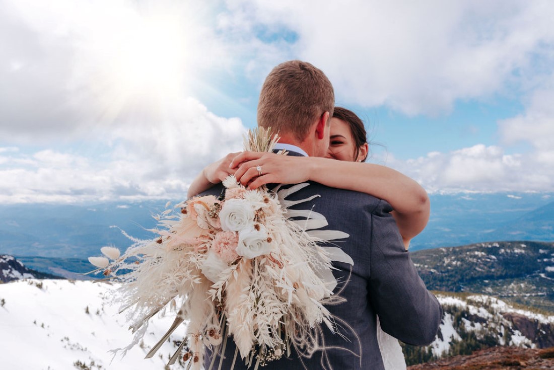 Wedding From Above Janayh Wright Photography hug shows off beautiful bouquet and ring