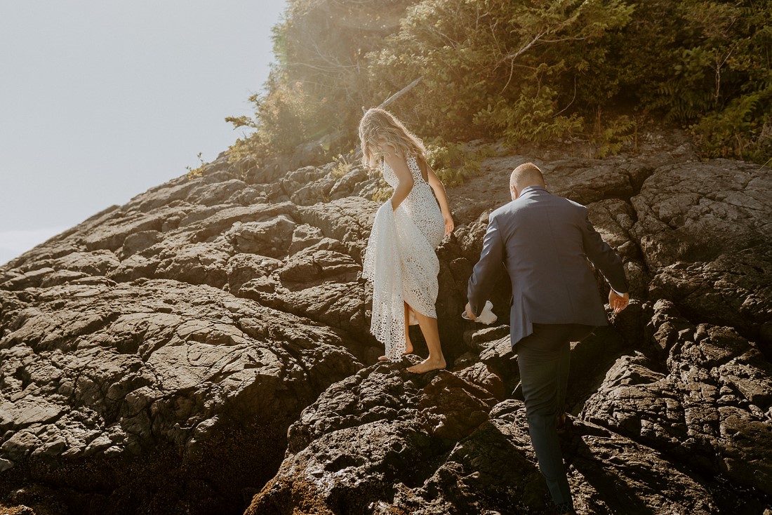 Beach Wed in Tofino couple climb rocks