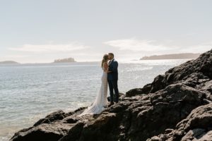 Beach Wed in Tofino newlyweds with ocean behind them