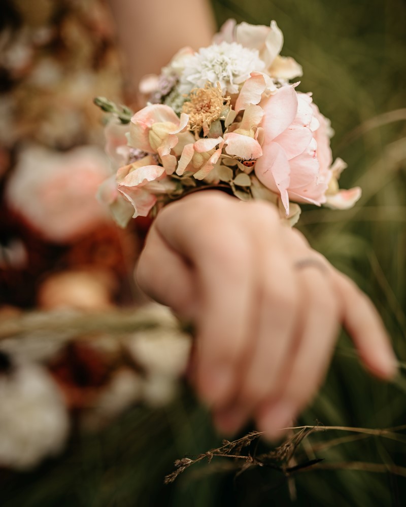 Bride wears flower bracelets and anklets