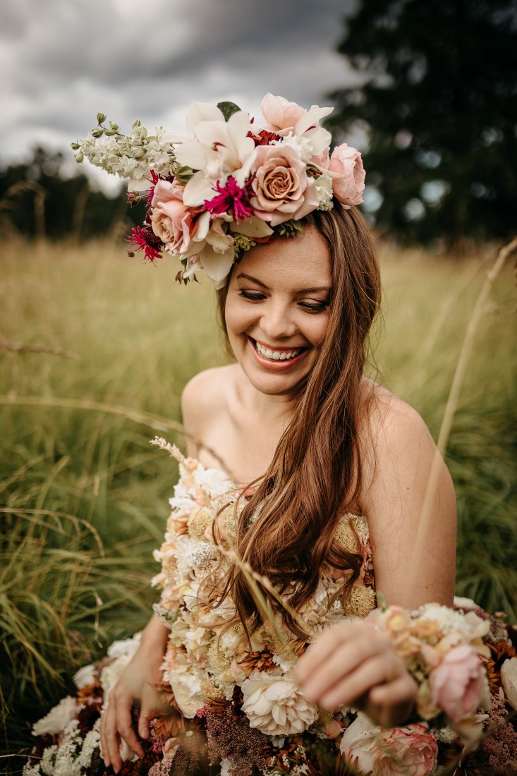 Flirty Floral Gown bride with head wreath of roses and orchids