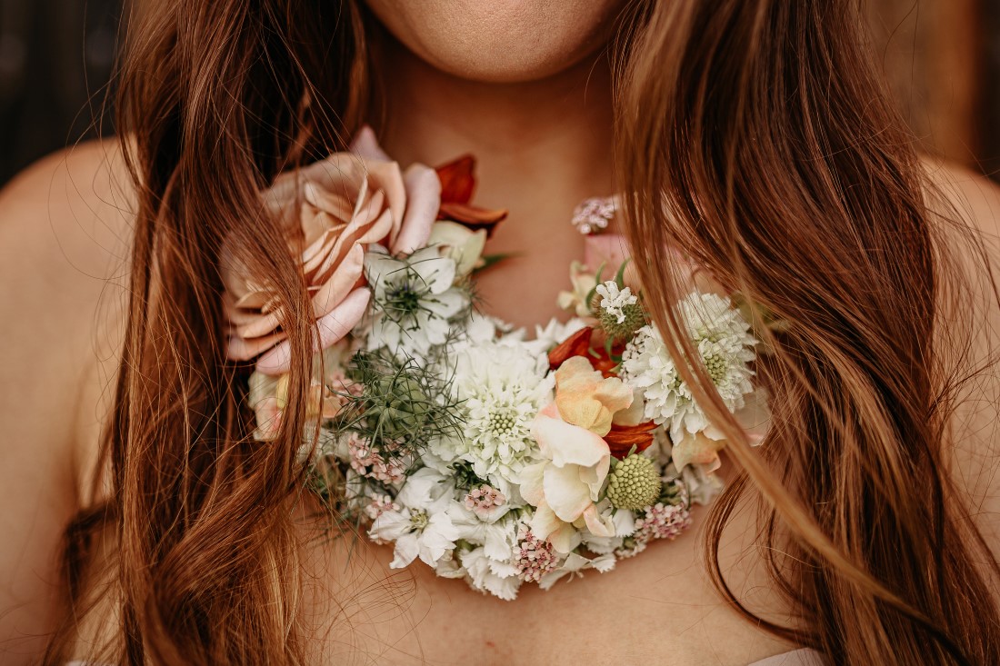Floral necklace of orchids and roses by Karen Bezaire