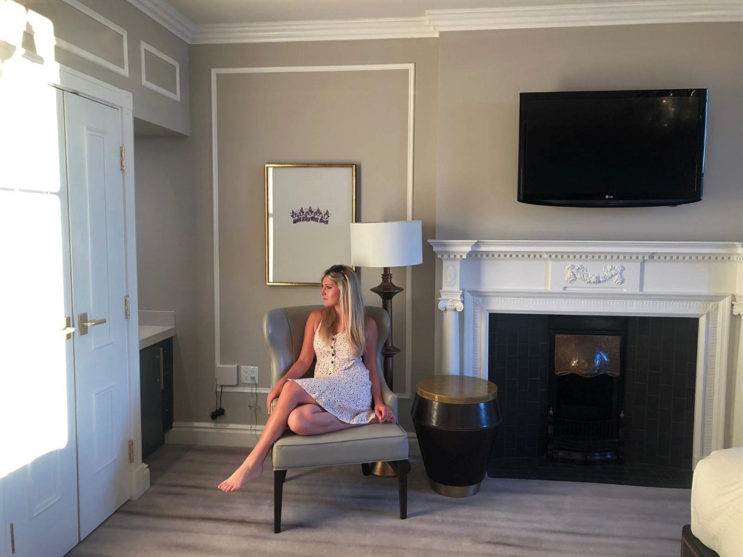 Bride sits in Fairmont Empress Junior Suite on honeymoon on Vancouver Island