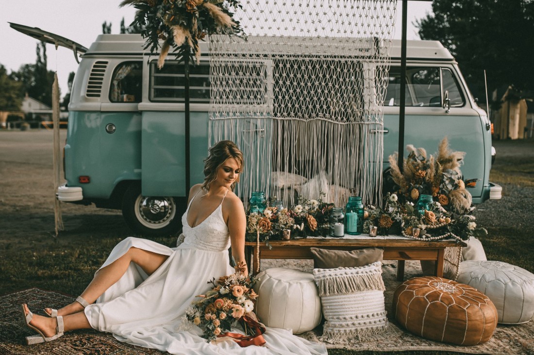 Bohemia Summer Westfalia bride sits on rugs and pillows