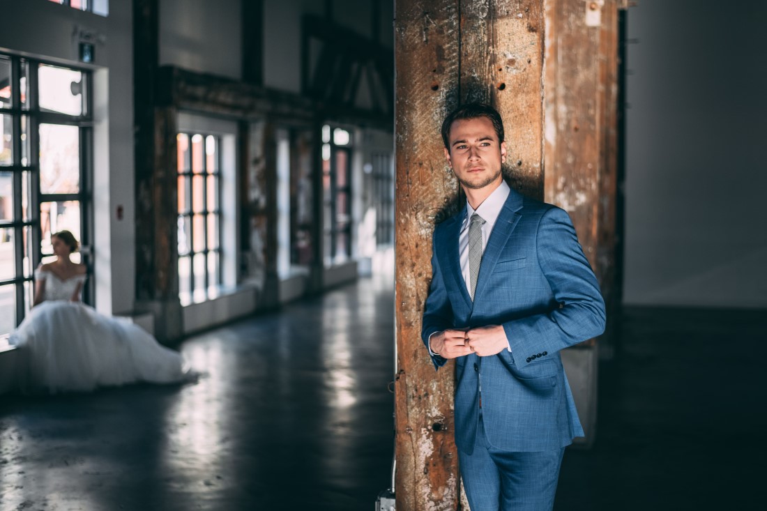 Laura Olson Photography Groom with Bride in background Golden Hour Wedding at The Vancouver Shipyards