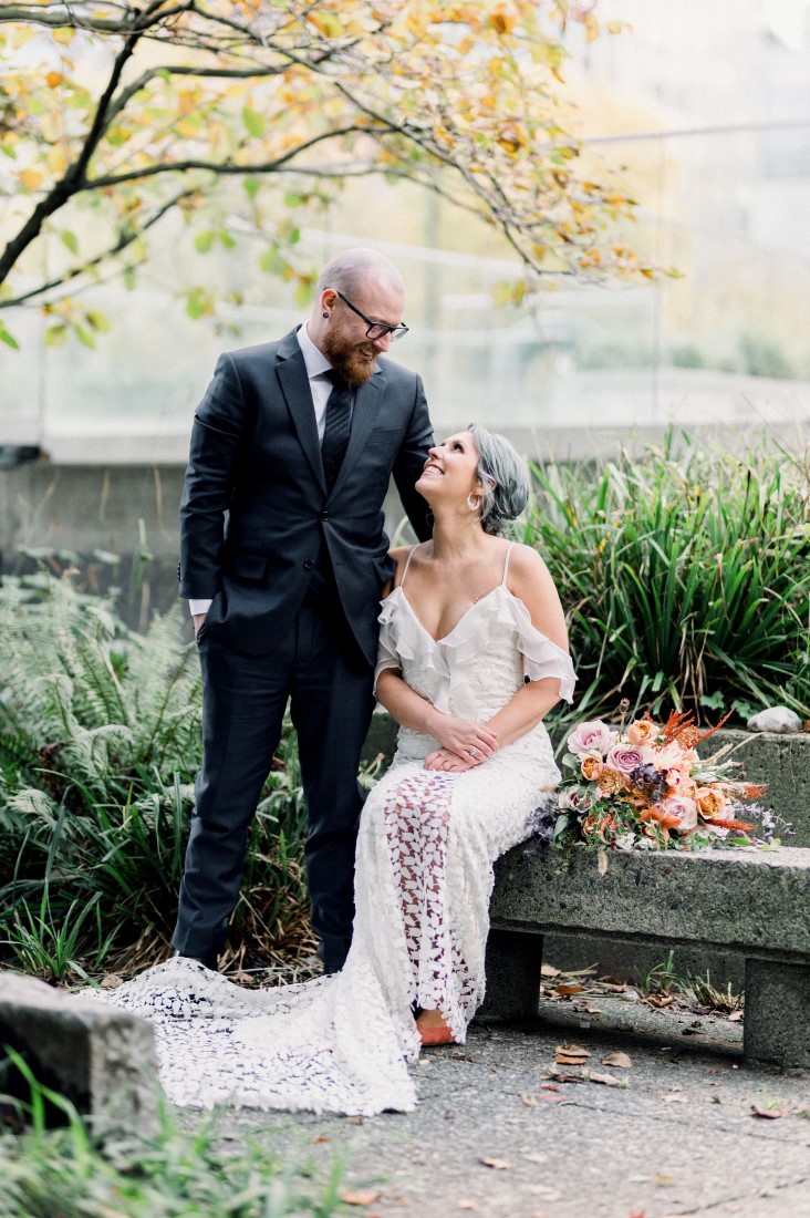Downtown Devotion newlyweds sit in city park