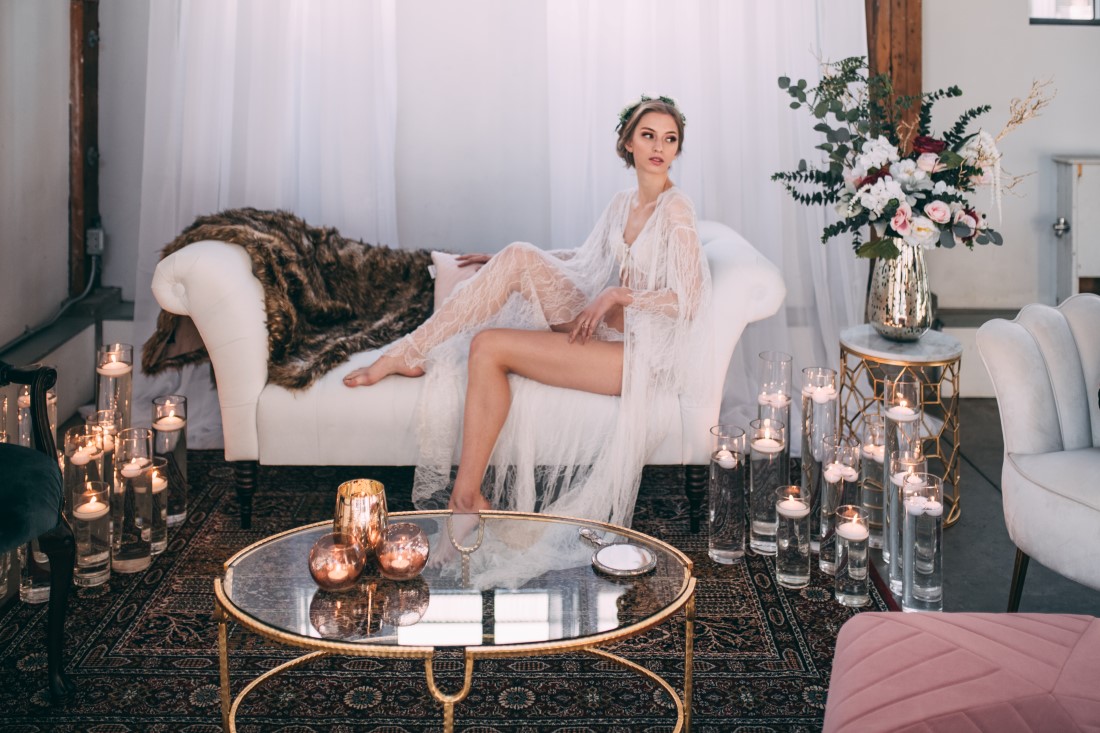 Bride in Lingerie sits on cream divan