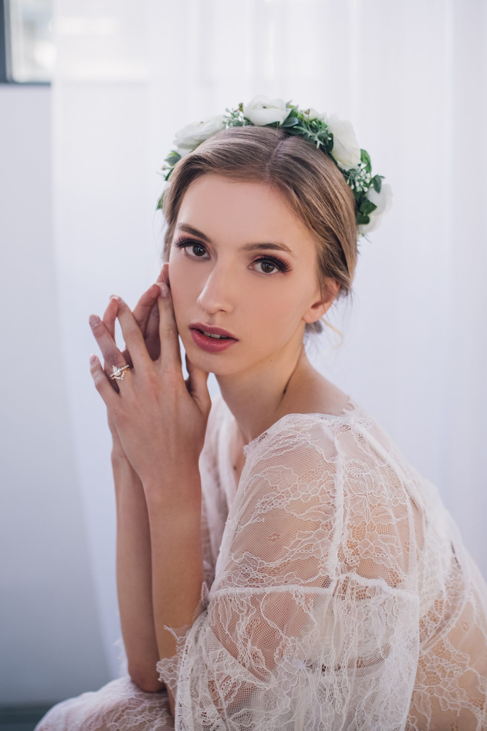 Bride in white lingerie looks at camera of Laura Olson