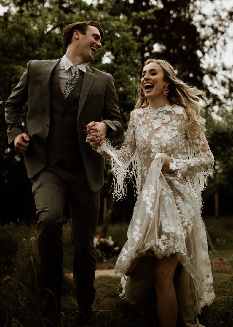 Bride and Groom hold hands at Keating Farm Vancouver Island