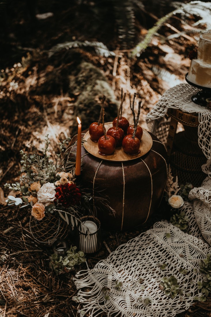 Red Candy Apples sit on barrel at Cedar Haven wedding venue