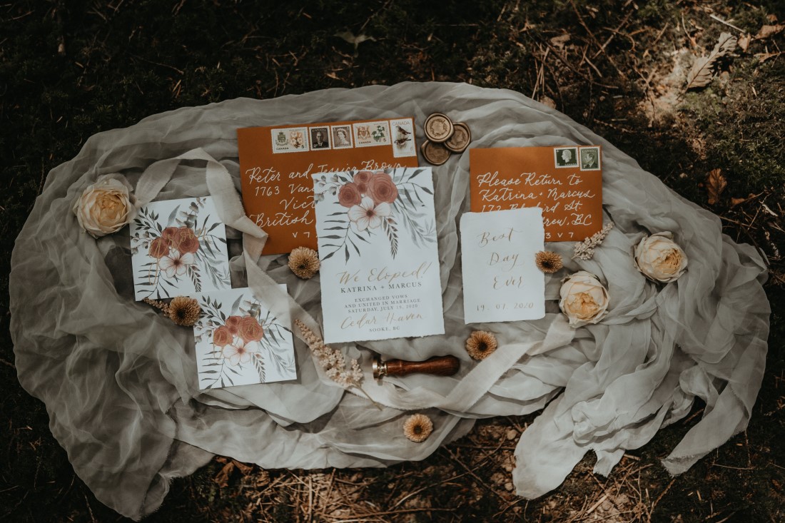White wedding invitations with tangerine flowers by Petite Paperie Design on Vancouver Island