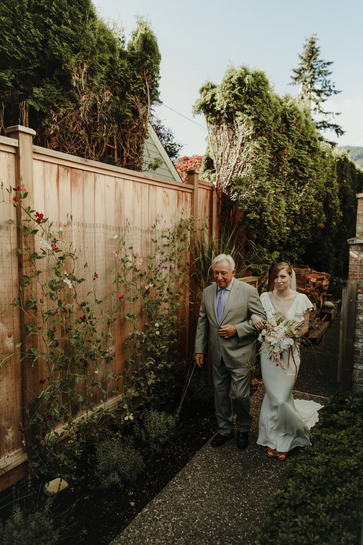 Bride and father walk down aisle in Vancouver backyard by DreamGroup Planners