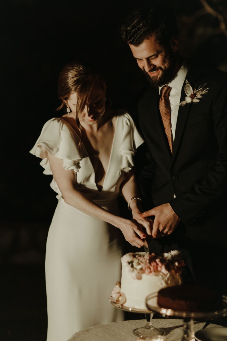 Newlyweds cut into wedding cake by Livia Sweets Vancouver