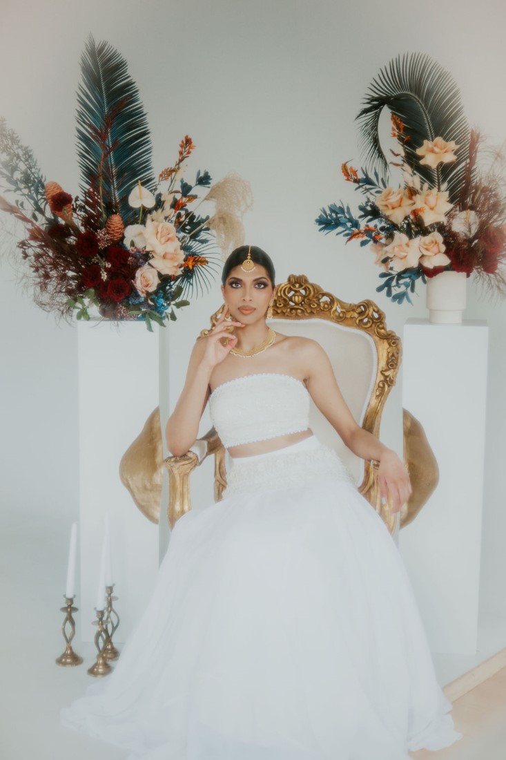 Bride in wicker chair with boho flower arrangements