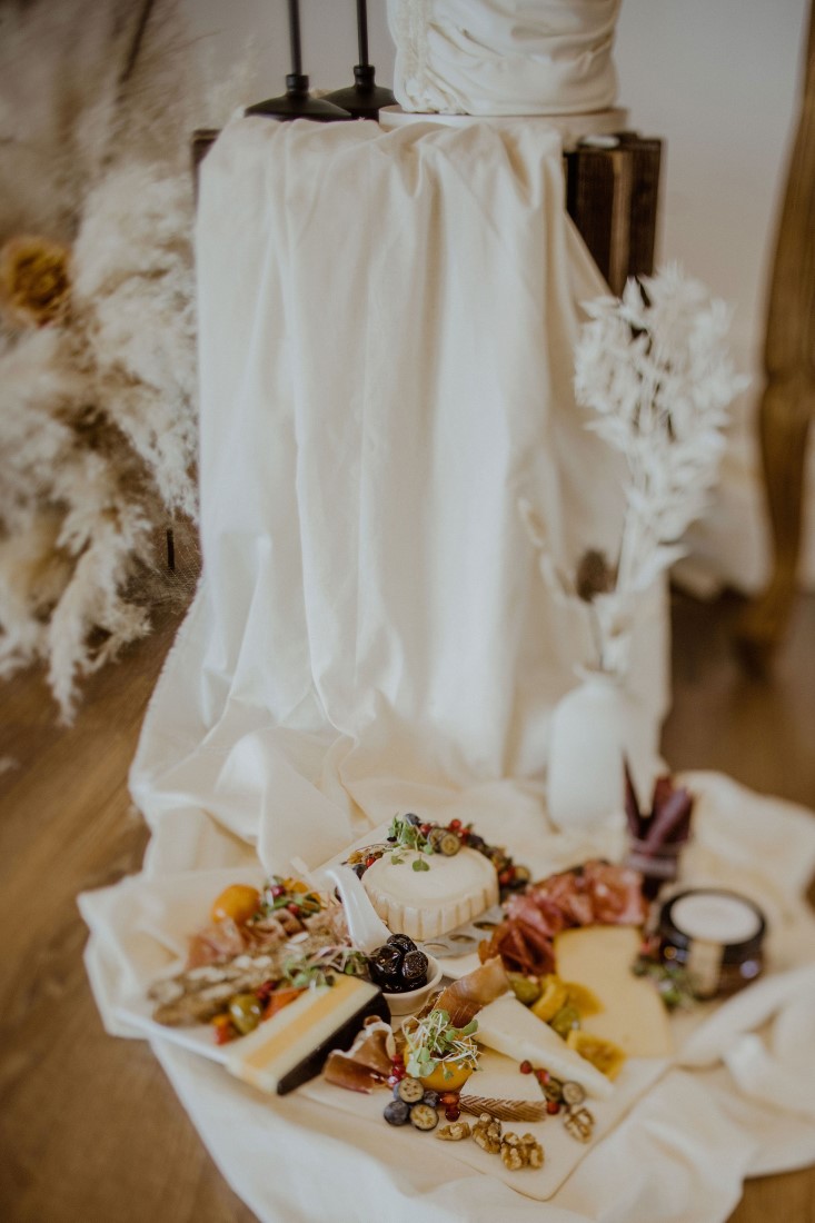 Charcuterie Board along the bottom of a wedding cake