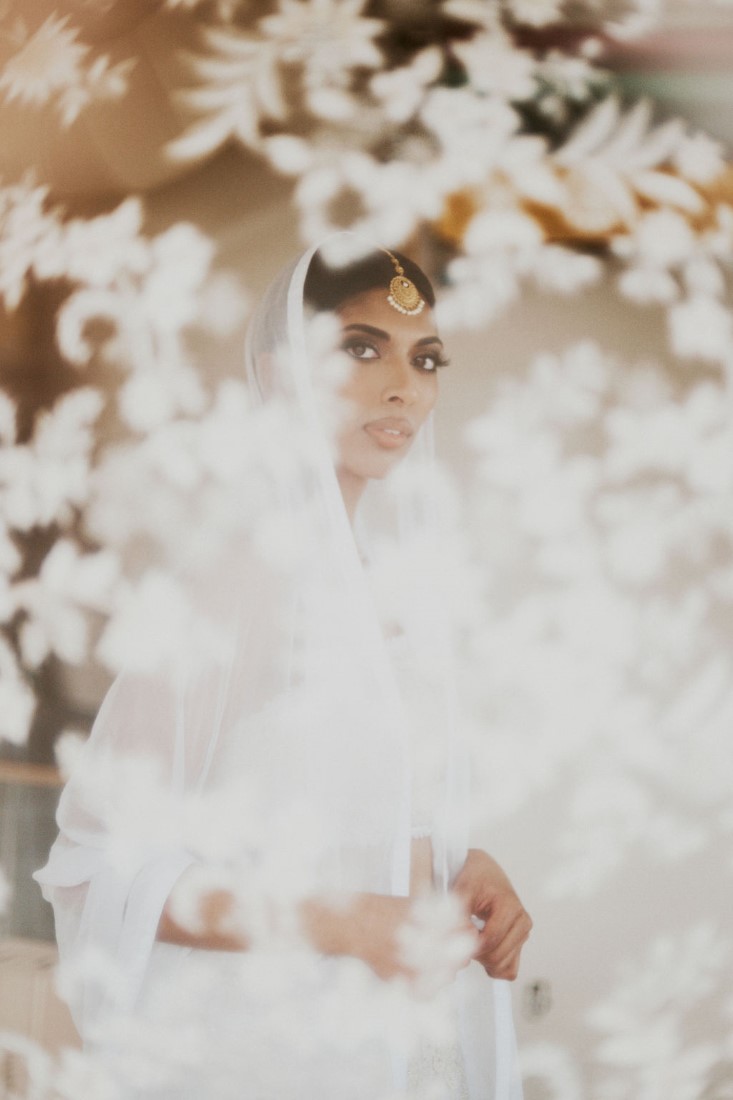 Bride looks through veil in Vancouver