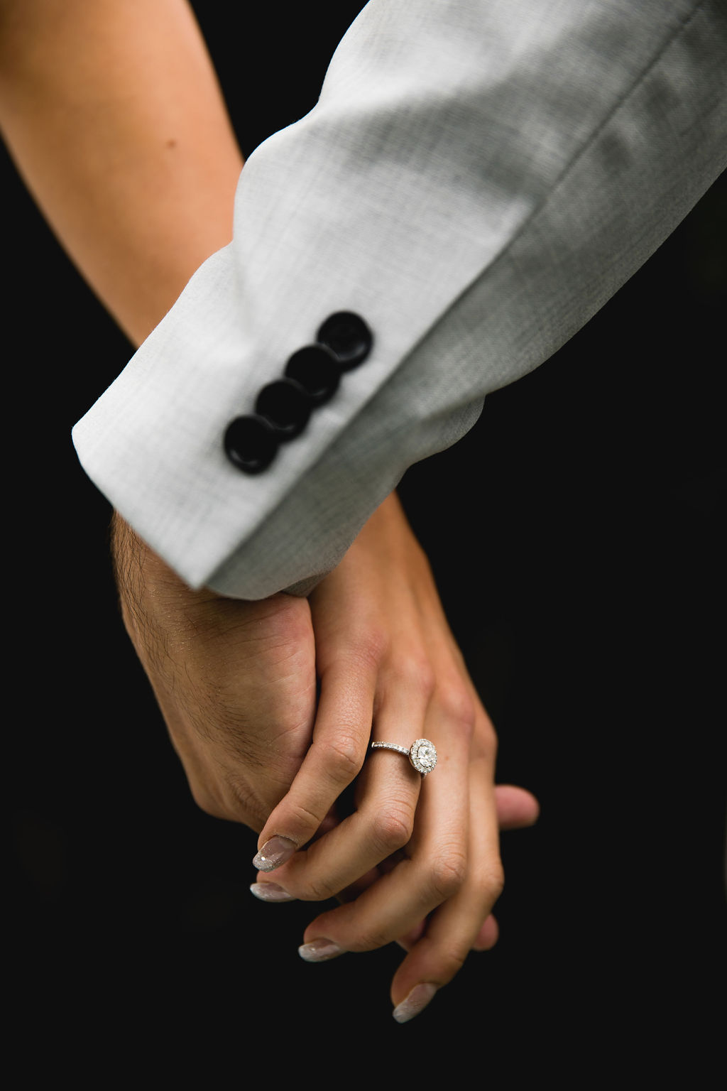 Bride and groom hold hands
