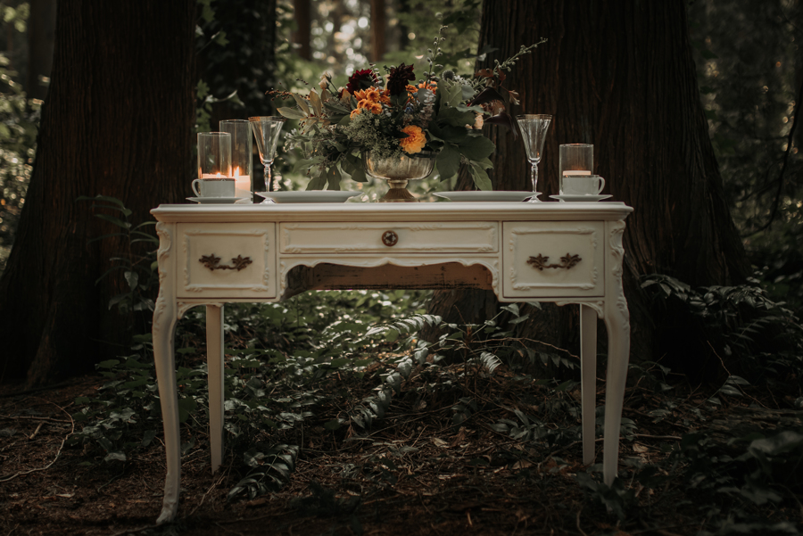 Vintage White Table with Wedding Reception Decor in the forest