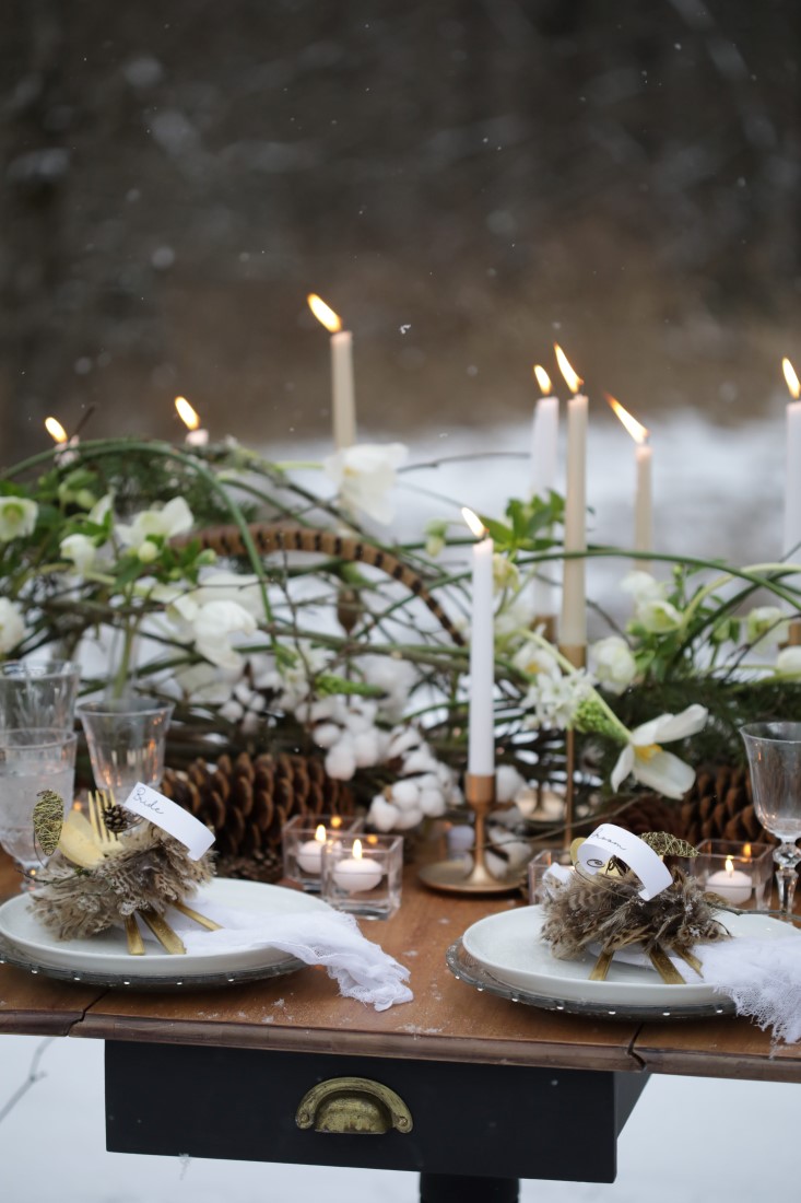 Winter wedding table with pine cones and taper candles