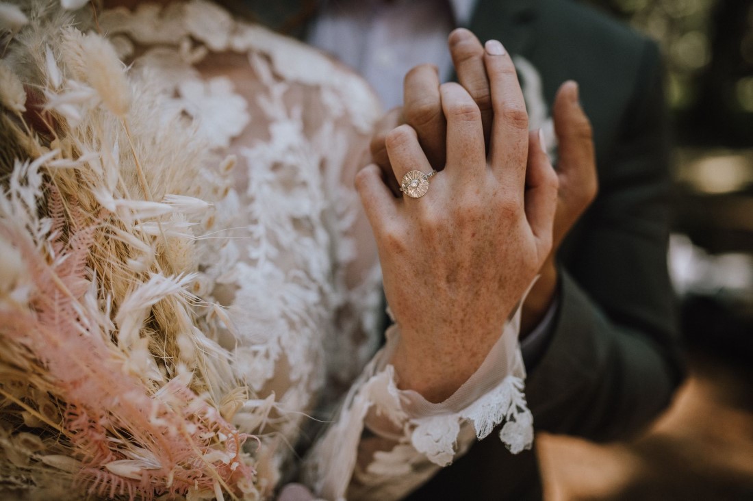 Forest Wedding bride and groom show off wedding rings