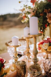 White pillar candles on gold candlesticks by Trend Decor on Vancouver Island