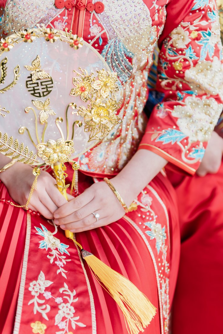Chinese fusion bride holds good luck flower in Vancouver