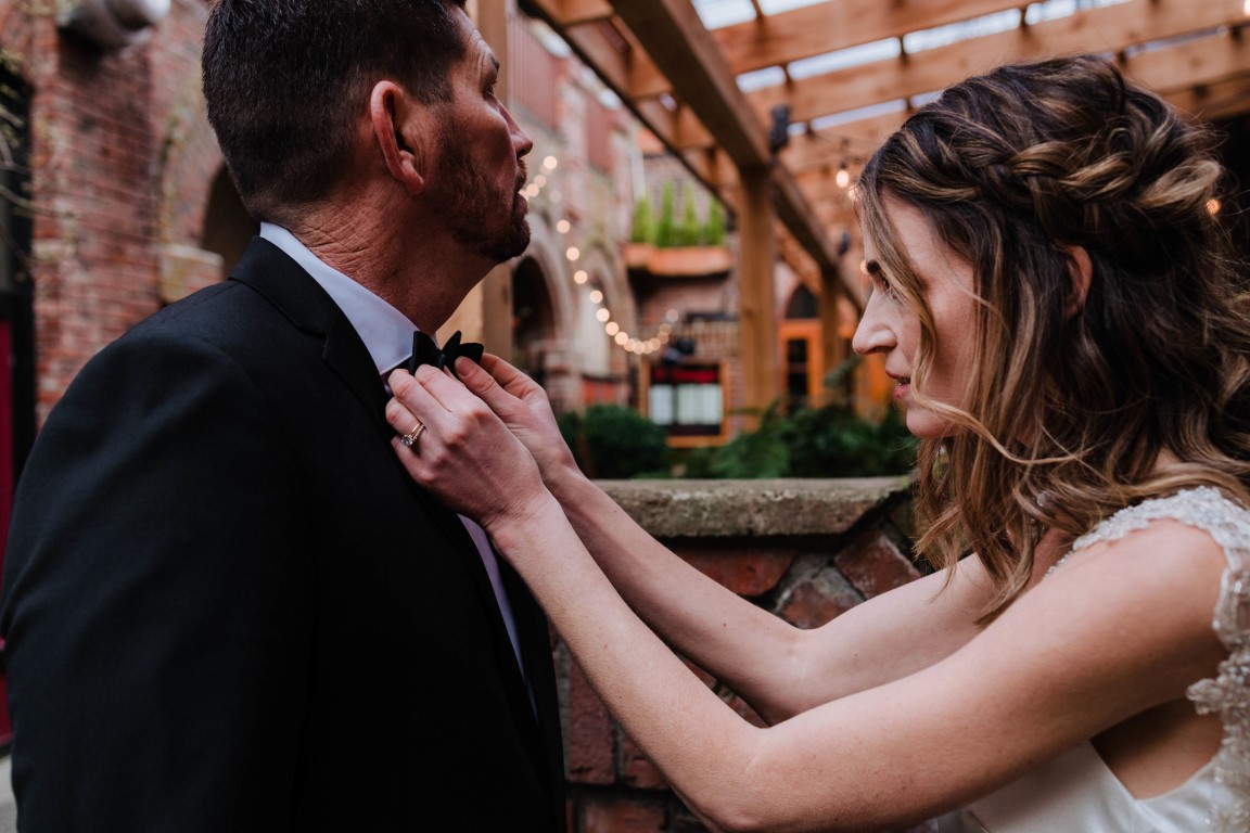 Bride adjusts grooms bowtie on Vancouver Island