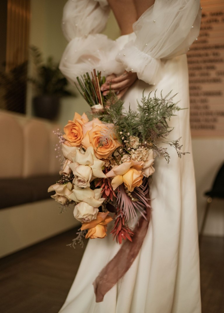 Playful and Pink bouquet with mixed roses, palm fans and a touch of greenery