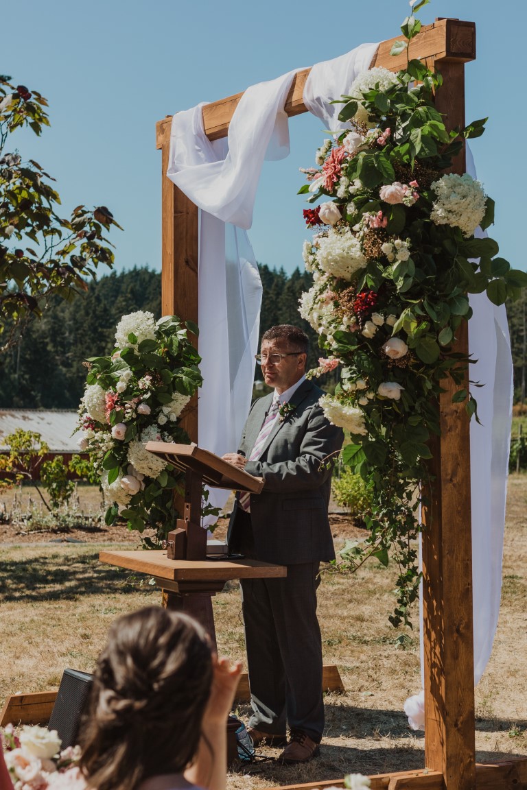 beautiful large floral display and fabric draping on ceremony arch