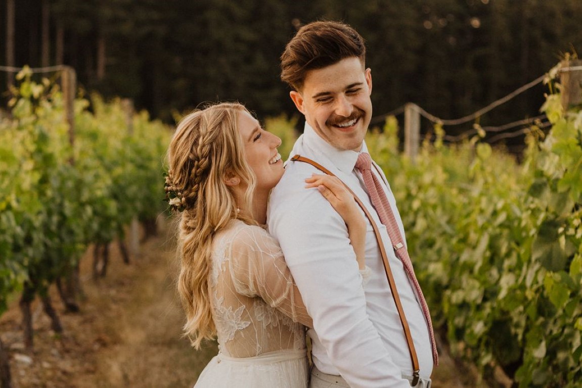 Sun Kissed Winery Wedding all smiles as bride hugs groom from behind