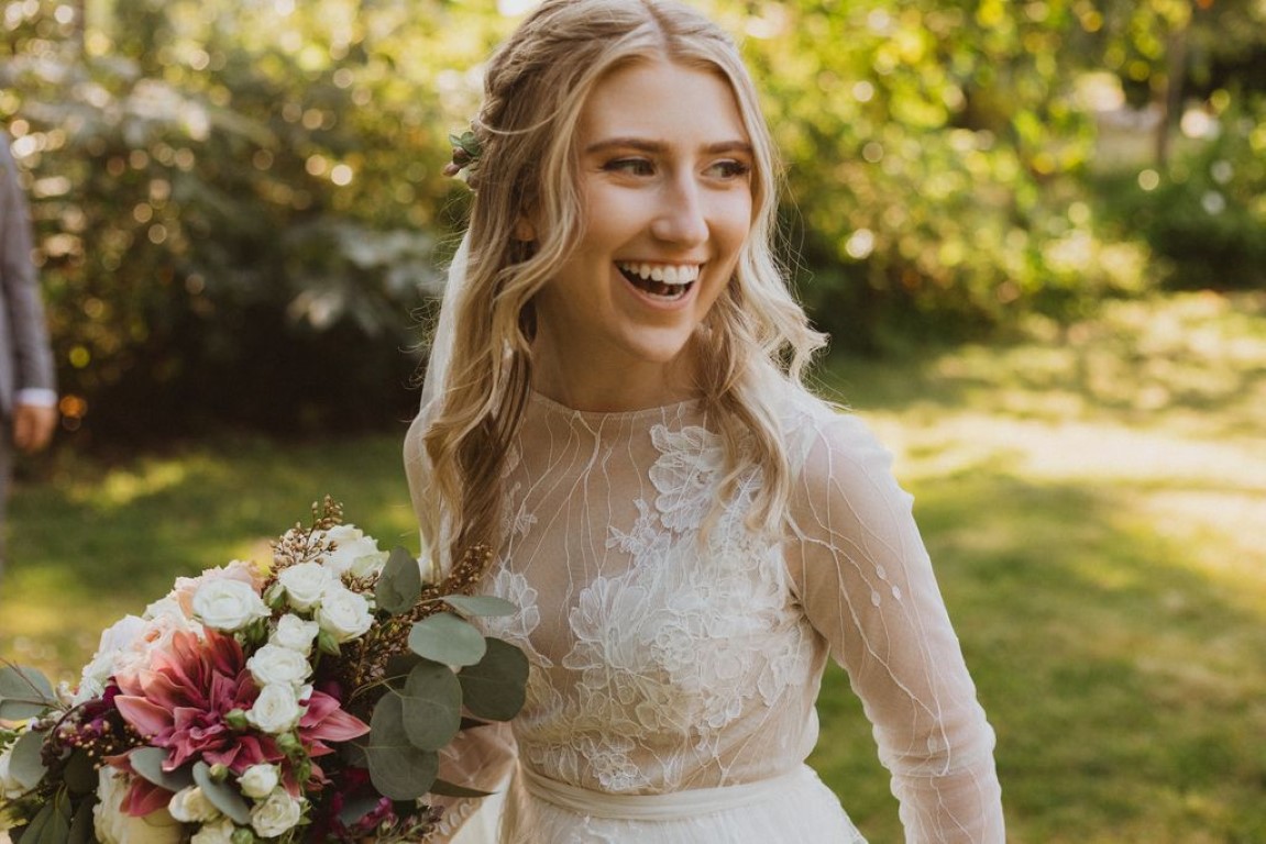 bride smiling at onlookers as she awaits ceremony
