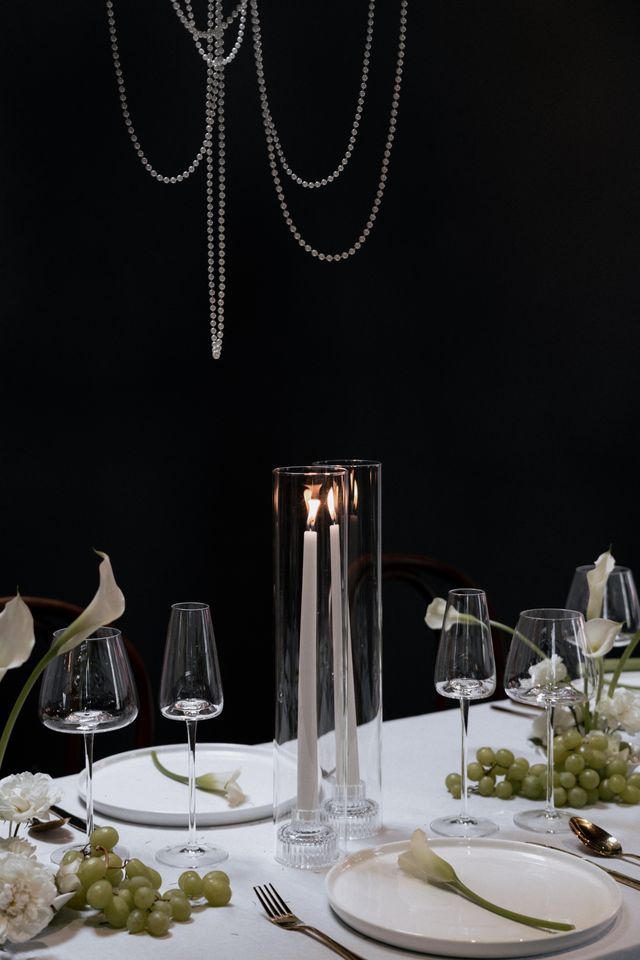 lit candles with grapes and pearls on vancouver wedding table