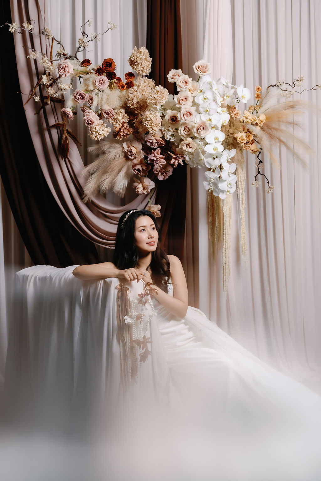 Bride gazes at rose installation by Luminous Floral Vancouver