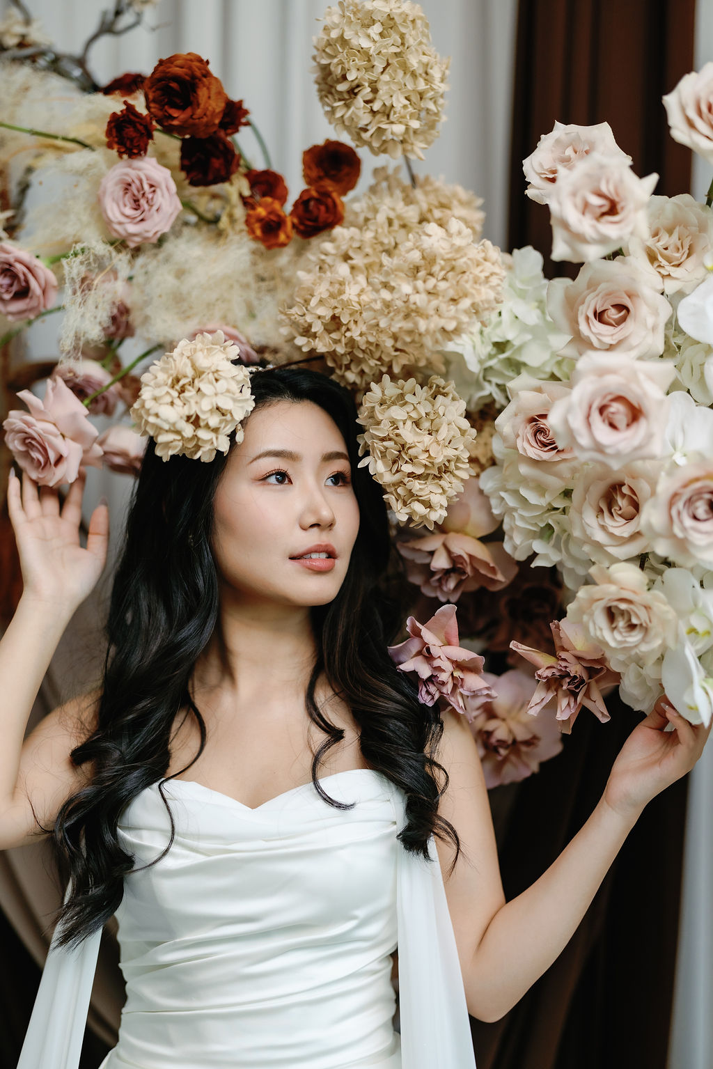 bride under beige and blush roses